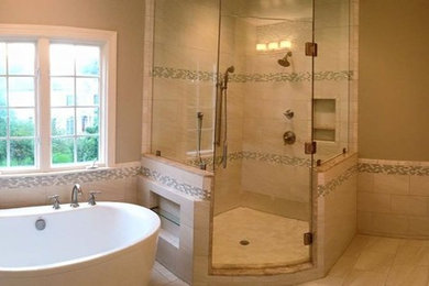 Photo of a mid-sized transitional master bathroom in DC Metro with recessed-panel cabinets, white cabinets, granite benchtops, brown benchtops, a freestanding tub, a corner shower, gray tile, white tile, glass tile, grey walls, porcelain floors, an undermount sink, a hinged shower door and grey floor.
