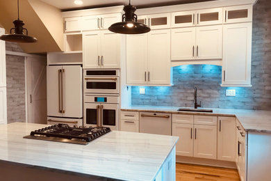 Inspiration for a large timeless u-shaped light wood floor, brown floor and exposed beam kitchen remodel in Baltimore with a single-bowl sink, shaker cabinets, white cabinets, quartzite countertops, blue backsplash, ceramic backsplash, white appliances, an island and white countertops