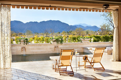 Inspiration for a mediterranean patio remodel in Los Angeles with a roof extension