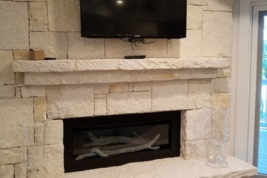 Inspiration for a contemporary family room remodel in Atlanta with white walls, a stone fireplace and a wall-mounted tv