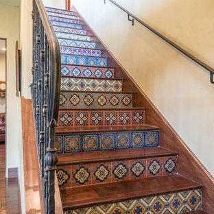 Medium sized mediterranean wood straight metal railing staircase in Austin with tiled risers.