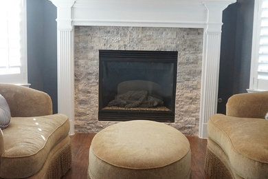 Elegant master porcelain tile bedroom photo in Houston with blue walls, a standard fireplace and a stone fireplace