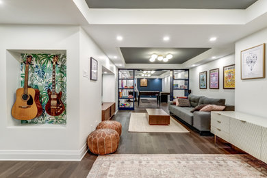 Example of a large brown floor, coffered ceiling and wallpaper basement game room design in Ottawa