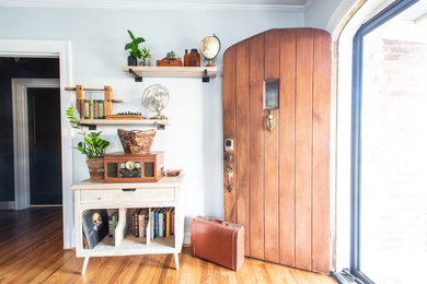 Inspiration for a small eclectic brown floor living room remodel in Nashville with a standard fireplace and a metal fireplace