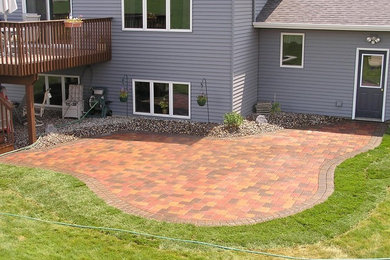 Small elegant backyard brick patio photo in Minneapolis with no cover