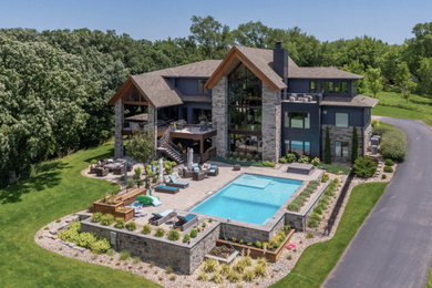 Pool landscaping - large contemporary backyard stone and rectangular pool landscaping idea in Other