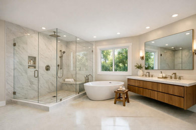 Trendy master marble tile marble floor and wallpaper bathroom photo in Orange County with beige walls, a hinged shower door and a floating vanity