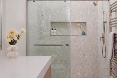 Inspiration for a contemporary master single-sink and gray floor alcove shower remodel in Los Angeles with flat-panel cabinets, light wood cabinets, quartz countertops, white countertops, a built-in vanity, gray walls and an undermount sink