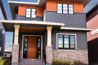 Inspiration for a mid-sized modern gray two-story wood flat roof remodel in Calgary