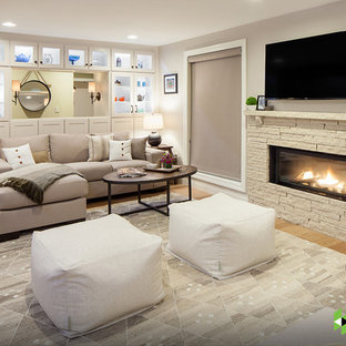 Bild på en vintage källare ovan mark, med grå väggar, en bred öppen spis, ljust trägolv och beiget golv