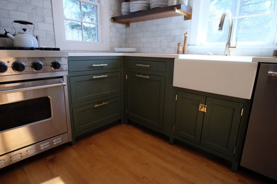 Inspiration for a small country u-shaped separate kitchen in New York with a farmhouse sink, shaker cabinets, green cabinets, marble benchtops, white splashback, ceramic splashback, stainless steel appliances, medium hardwood floors, no island, brown floor and white benchtop.