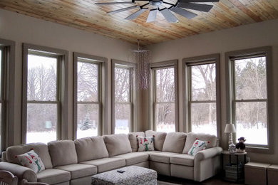 Mid-sized elegant medium tone wood floor and brown floor sunroom photo in Milwaukee with no fireplace and a standard ceiling