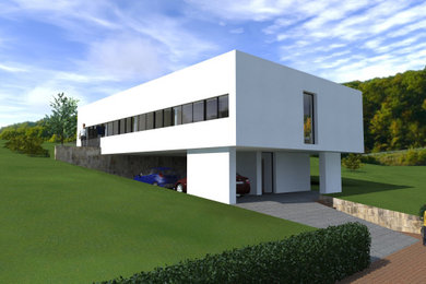 Großes, Zweistöckiges Modernes Einfamilienhaus mit Betonfassade, weißer Fassadenfarbe und Flachdach in Sonstige