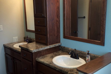 Bathroom - bathroom idea in Other with flat-panel cabinets, dark wood cabinets, laminate countertops and blue walls