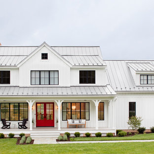 Inspiration for a country white two-story wood and board and batten exterior home remodel in Baltimore with a metal roof
