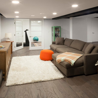 This is an example of a medium sized contemporary walk-out basement in New York with white walls, no fireplace, porcelain flooring and brown floors.