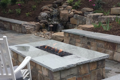 Mid-sized trendy backyard concrete paver patio photo in Other with no cover