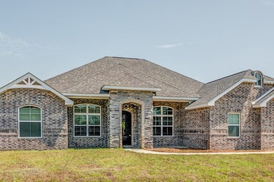 Example of a large classic one-story house exterior design in Other with a shingle roof