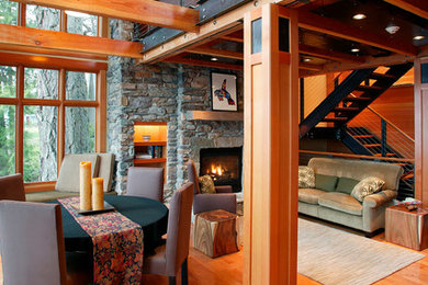 Inspiration for a mid-sized rustic formal and open concept medium tone wood floor and brown floor living room remodel in Seattle with beige walls, a standard fireplace, a stone fireplace and no tv