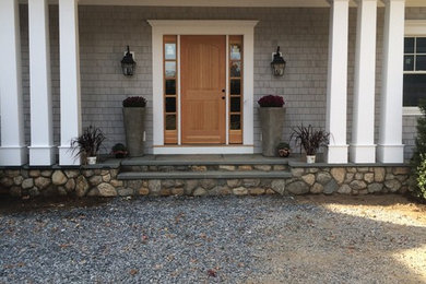 Entryway - large transitional entryway idea in New York with gray walls and a medium wood front door