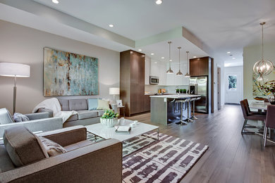 Mid-sized trendy open concept medium tone wood floor living room photo in Calgary with white walls, no fireplace and no tv