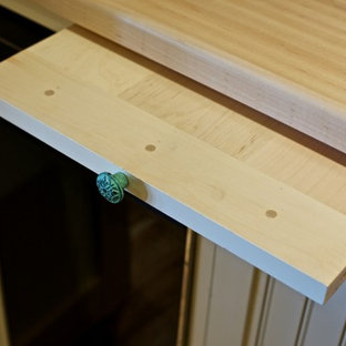 Mid-sized beach style kitchen pantry inspiration - Mid-sized coastal kitchen pantry photo in Manchester with a farmhouse sink, beaded inset cabinets, white cabinets and wood countertops