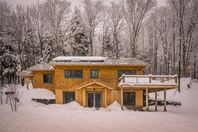 Example of an arts and crafts wood exterior home design in Burlington