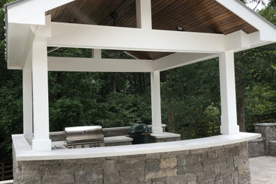 Patio kitchen - mid-sized backyard concrete paver patio kitchen idea in Nashville with a gazebo