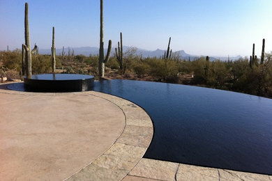 Mid-sized trendy backyard concrete and custom-shaped infinity hot tub photo in Phoenix