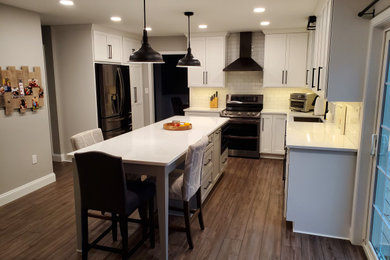 Inspiration for a mid-sized timeless l-shaped eat-in kitchen remodel in Other with shaker cabinets, white cabinets, quartz countertops and an island