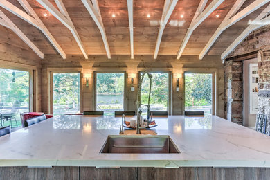Example of a large trendy single-wall slate floor eat-in kitchen design in Philadelphia with an undermount sink, flat-panel cabinets, gray cabinets, quartzite countertops, paneled appliances and an island