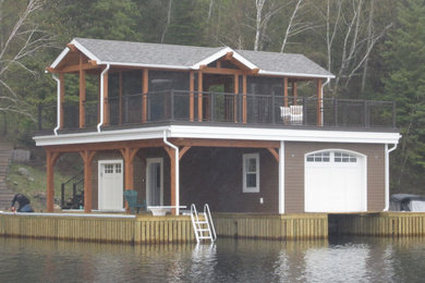 Example of a large classic brown two-story house exterior design in Other with a shingle roof and a gray roof