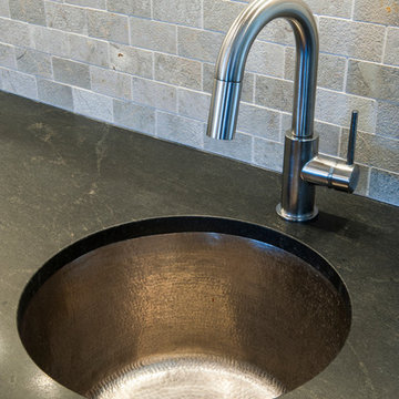 Undermount, Hammered Sink, Stone Tile Backsplash, and Honed Granite Countertop