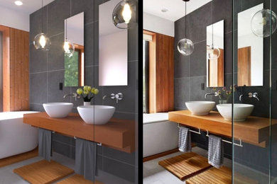 Exemple d'une salle de bain principale moderne de taille moyenne avec une baignoire indépendante, une douche ouverte, un carrelage noir et blanc, des carreaux en terre cuite, un lavabo posé, un plan de toilette en bois et meuble double vasque.