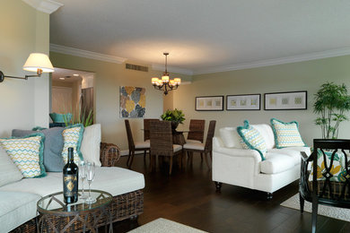 Inspiration for a mid-sized tropical open concept dark wood floor living room remodel in Miami with green walls, no fireplace and a wall-mounted tv