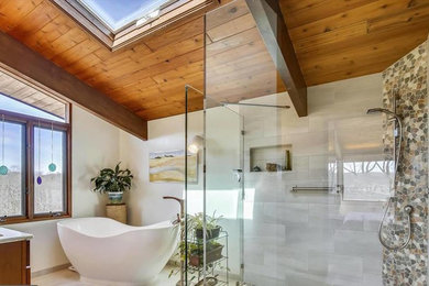 Photo of a large contemporary master bathroom in DC Metro with medium wood cabinets, a freestanding tub, a curbless shower, a two-piece toilet, white tile, porcelain tile, white walls, porcelain floors, an undermount sink, engineered quartz benchtops, white floor, an open shower and beige benchtops.