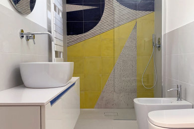 Walk-in shower - mid-sized mediterranean master yellow tile and ceramic tile porcelain tile, white floor and single-sink walk-in shower idea in Naples with white cabinets, a two-piece toilet, white walls, a vessel sink, laminate countertops, white countertops, a niche and a floating vanity