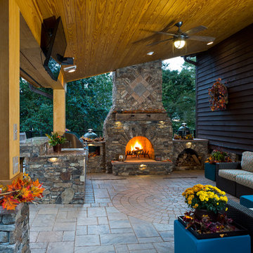 Outdoor fireplace with grill island and big green egg