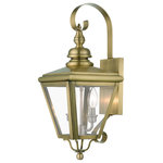 Livex Lighting - Adams 2-Light Antique Brass Outdoor Medium Wall Lantern, Brushed Nickel Cluster - The stylish antique brass finish outdoor Adams wall lantern is a great way to update your home's exterior decor. A flat metal curved arm attaches the solid brass decorative housing to the square backplate while clear glass shows off the brushed nickel finish cluster.