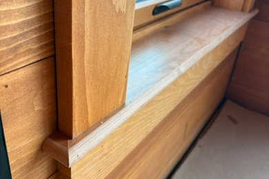 Example of a danish wood wall living room design in Manchester