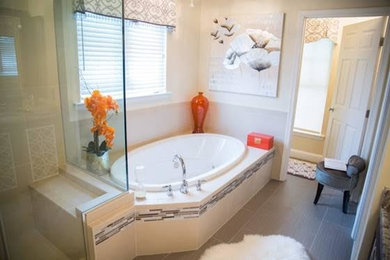 This is an example of a mid-sized contemporary master bathroom in Philadelphia with raised-panel cabinets, dark wood cabinets, a drop-in tub, multi-coloured tile, porcelain tile, granite benchtops, a double shower, a two-piece toilet, white walls and porcelain floors.