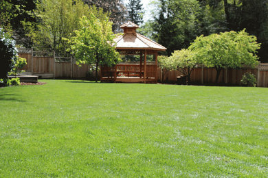 Photo of a large farmhouse partial sun backyard brick formal garden in Vancouver.
