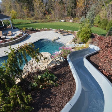 Custom Freeform style salt water in ground pool with Waterslide and Spa