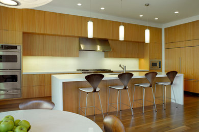 Inspiration for a modern galley eat-in kitchen remodel in San Francisco with paneled appliances, an undermount sink, flat-panel cabinets, light wood cabinets and white backsplash