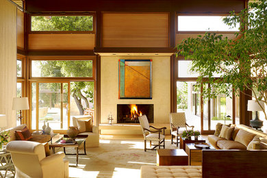 Expansive contemporary open concept living room in San Francisco with beige walls, a standard fireplace, carpet, a tile fireplace surround, no tv and beige floor.