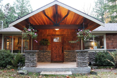 Mid-sized elegant front porch photo in Seattle with a roof extension