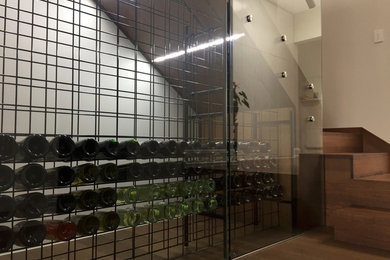 Photo of a contemporary wine cellar in Melbourne with storage racks.
