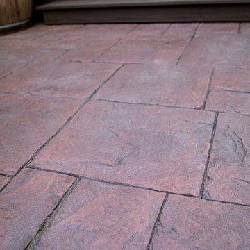 Boulder Patio Cover with Deckorators Decking and Railing and Stamped Concrete