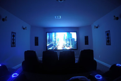 Home theater - mid-sized traditional enclosed carpeted and beige floor home theater idea in New York with beige walls and a projector screen