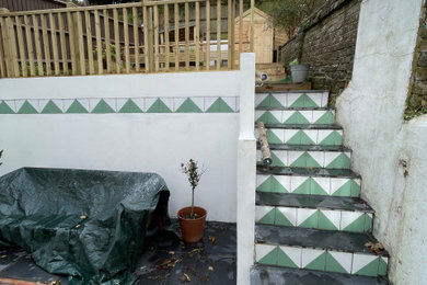 Photo of a small modern partial sun courtyard concrete paver and wood fence landscaping in Sussex for summer.